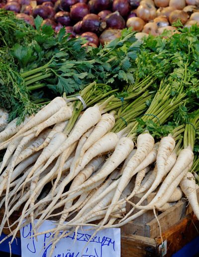 Bunch of parsley roots (large early tuberous parsley) on a market stall.